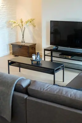a living room with a couch and a coffee table at SN Logies in Tremelo