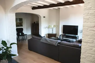 a living room with a couch and a flat screen tv at SN Logies in Tremelo