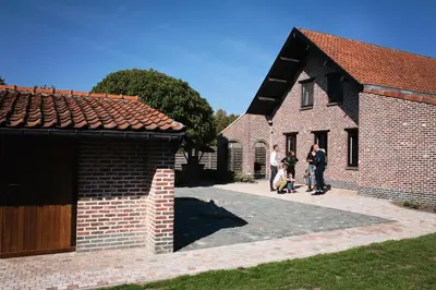 a group of people standing outside of a brick building at SN Logies in Tremelo