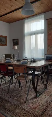 a large wooden table with wine glasses on top of it at De oude statie in Tessenderlo
