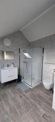 a bathroom with a shower and a sink and a toilet at De oude statie in Tessenderlo