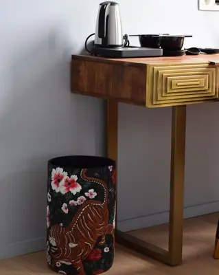 a trash can sitting under a table next to a table at Hôtel La Pièce in Brussels
