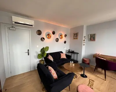 a living room with two couches and a table at Hôtel La Pièce in Brussels