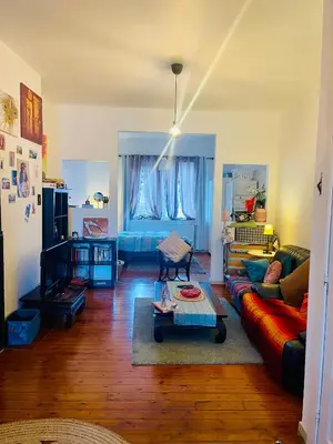 a living room with a couch and a table at Quiet and Colorfull Flat in the Center City of Brussels in Brussels
