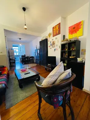 a living room with a couch and a table at Quiet and Colorfull Flat in the Center City of Brussels in Brussels