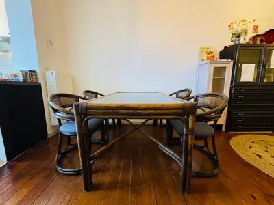 a table with chairs around it in a room at Quiet and Colorfull Flat in the Center City of Brussels in Brussels