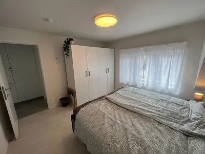 a bedroom with a large bed and a window at Holiday Home De Steenen Molen in Brecht