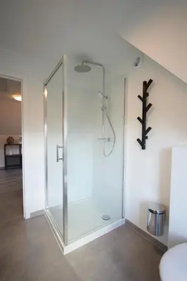 a glass shower in a room with at Holiday Home De Steenen Molen in Brecht