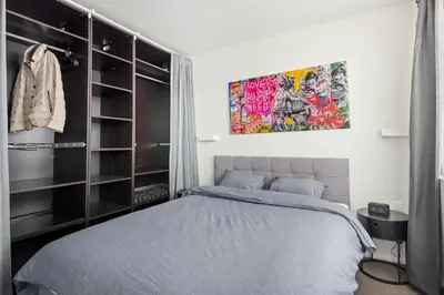 a bedroom with a bed and a painting on the wall at Ernest 33 in Antwerp