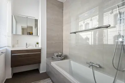 a bathroom with a bath tub and a sink at Ernest 33 in Antwerp