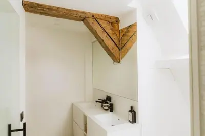 a bathroom with a sink and a wooden ceiling at Kozy Home Spacious Luxurious home in Antwerp
