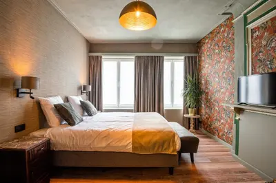 a bedroom with a bed and a large window at Boutique hotel Sies in Watervliet