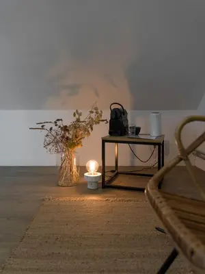 a room with a table with a candle and a table with a bag at Julie's Boutique Guesthouse Ghent in Ghent