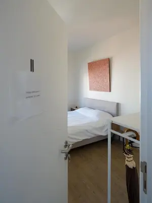 a small bedroom with a bed and a desk at Julie's Boutique Guesthouse Ghent in Ghent