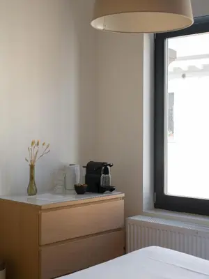 a bedroom with a dresser and a window at Julie's Boutique Guesthouse Ghent in Ghent