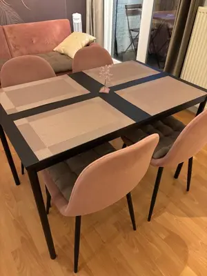 a table and chairs with a table and a couch at Coco’s place in Antwerp