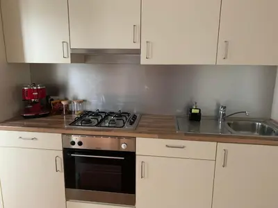 a kitchen with a stove and a sink at Coco’s place in Antwerp