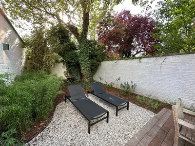 two black chairs and a table in a garden at Historic 3 Bedroom Art-Nouveau Apartment with Airconditioning - Walk to Station Gent Sint-Pieters & Close to City Centre in Ghent