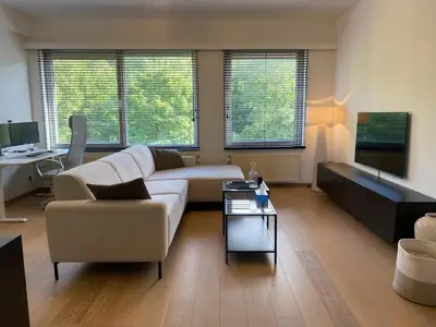 a living room with a couch and a table at Cosy Apartment near Antwerp in Mortsel
