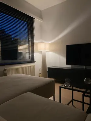 a bedroom with a bed and a flat screen tv at Cosy Apartment near Antwerp in Mortsel