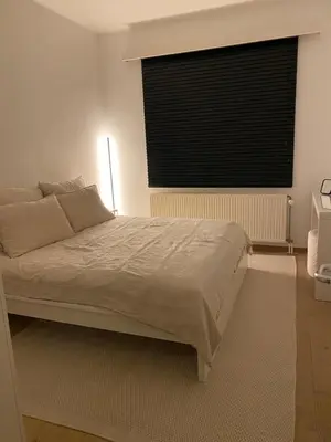 a bedroom with a large bed with a window at Cosy Apartment near Antwerp in Mortsel