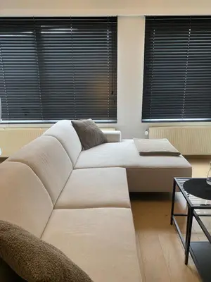 a bedroom with a large white bed and windows at Cosy Apartment near Antwerp in Mortsel