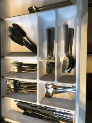 a refrigerator filled with silver utensils at Vakantiewoningeikenhof in Londerzeel