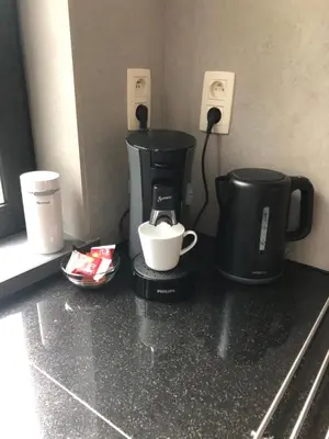 a coffee maker and a coffee pot on a counter at Vakantiewoningeikenhof in Londerzeel