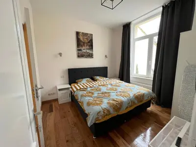 a bedroom with a bed and a window at Design europarlament apartment with private terrace in Brussels