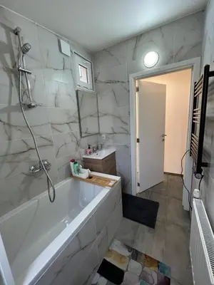 a white bathroom with a tub and a sink at Design europarlament apartment with private terrace in Brussels