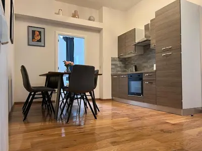 a kitchen with a table and chairs in a room at Design europarlament apartment with private terrace in Brussels