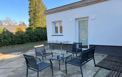 a group of chairs and a table in front of a building at Les Cerisettes in Wavre