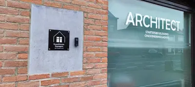 a store window with a sign on a brick wall at Fitness loft 50 m2 in Zemst