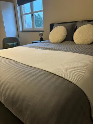 a bedroom with a bed with two pillows on it at De Kempische Akker in Westerlo