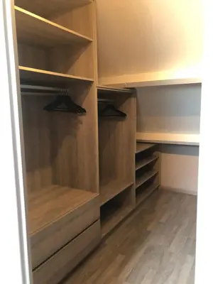 a walk in closet with wooden shelves at De Kempische Akker in Westerlo