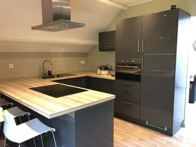 a kitchen with black appliances and a wooden counter top at De Kempische Akker in Westerlo