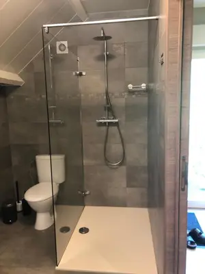 a bathroom with a shower with a toilet at De Kempische Akker in Westerlo