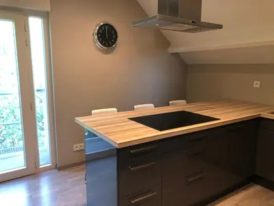 a kitchen with a wooden counter top with a sink at De Kempische Akker in Westerlo