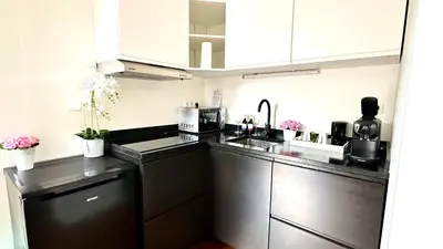 a small kitchen with a sink and a microwave at Royal Horses in Overijse