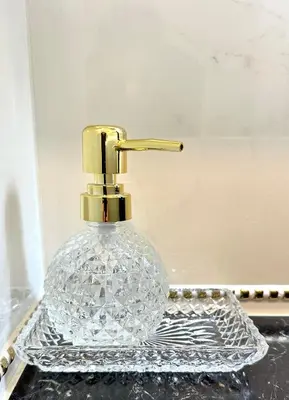 a clear glass perfume bottle with a gold faucet at Royal Horses in Overijse