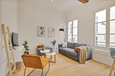a living room with a blue couch and a table at Beautiful cosy apartments in the heart of Antwerp in Antwerp