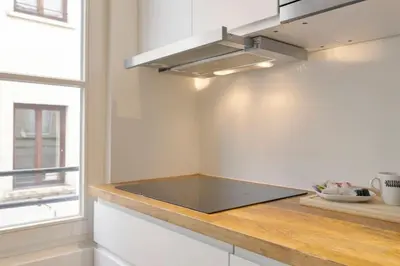 a kitchen with a counter with a stove top at Beautiful cosy apartments in the heart of Antwerp in Antwerp