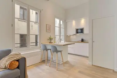 a kitchen with a table and chairs in a room at Beautiful cosy apartments in the heart of Antwerp in Antwerp