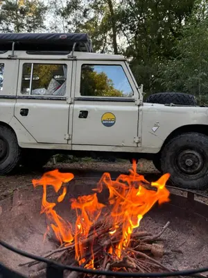 a white jeep parked next to a fire at TerraVenturia - Defcamp in Rixensart