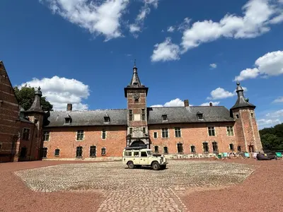 an old building with a jeep parked in front of it at TerraVenturia - Defcamp in Rixensart