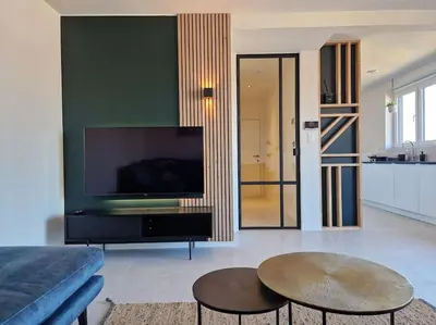 a living room with a large flat screen tv at Phoenix in Ghent