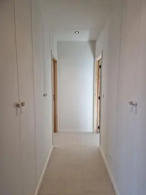 an empty hallway with white walls and white doors at Phoenix in Ghent