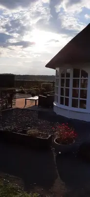 a house with two flower pots in front of it at Kamer 22 Bed & Breakfast in Poppel