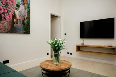 a living room with a vase of flowers on a table at Beauty Suite in Brussels