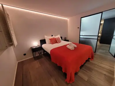 a bedroom with a bed with a stuffed animal on it at luxe en authenticiteit in Antwerp